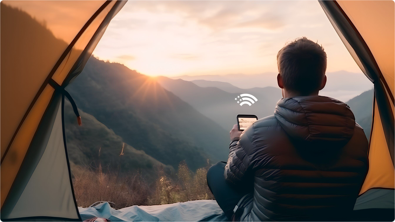 Camper checking wireless service from a mountain tent